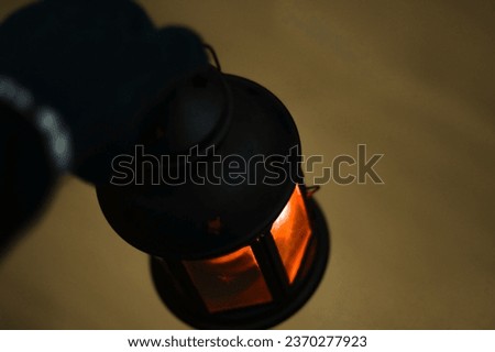 Closeup hand holding lantern with flame at night holy picture concept of greetings for christmas and new year