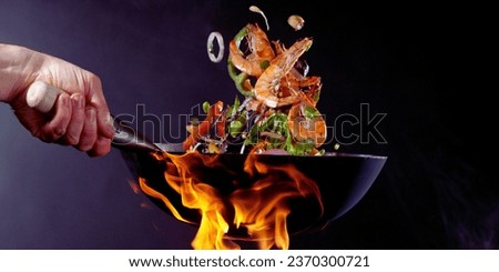 Sizzling Food in a Frying Pan, 
Cooking Delicious Meal in a Skillet, 
Chef's Frying Pan with Tasty Dish, 
Culinary Art: Pan-Frying Perfection, 
Kitchen Cooking: Frying Pan on Stove Royalty-Free Stock Photo #2370300721