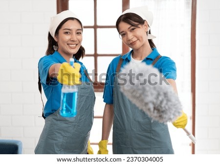 Portrait two Asia woman in workwear maid cleaning home and holding dusting brush and microfiber cloth in her hand at home	 Royalty-Free Stock Photo #2370304005