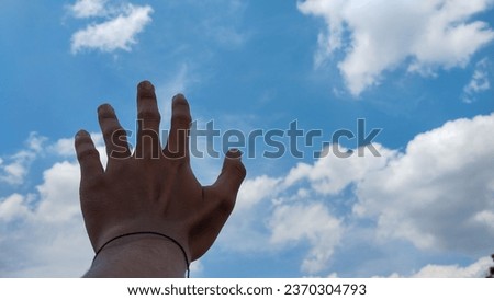 Hands waving to the bright and beautiful sky