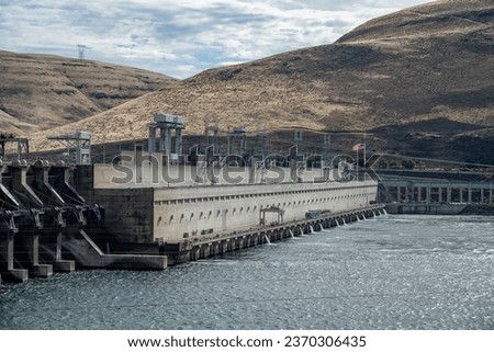The John Day Dam powerhouse contains 16 turbines with a total electric generation capactiy of 2,160 mW making it the 4th most productive dam in the USA. Royalty-Free Stock Photo #2370306435