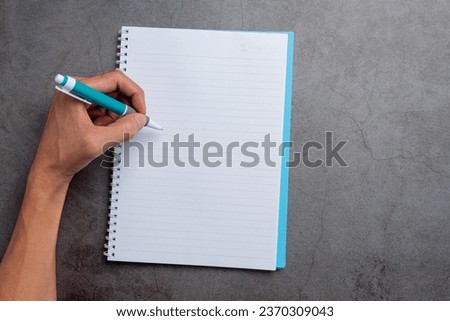 a woman left-hand with a pen.Left hander day concept.  Royalty-Free Stock Photo #2370309043