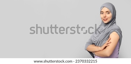 Muslim woman with medical patch on arm against grey background with space for text. Vaccination concept