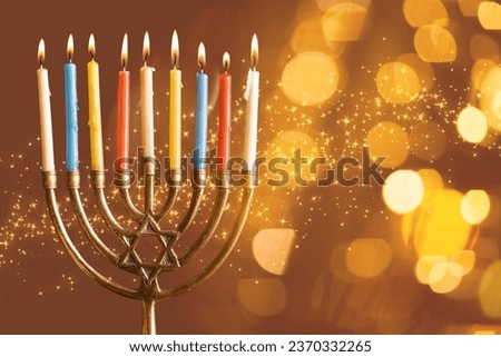 Burning candles for Hannukah celebration on brown background with space for text Royalty-Free Stock Photo #2370332265