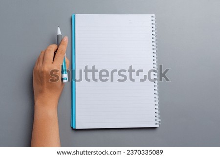 a woman left-hand with a pen.Left hander day concept. 