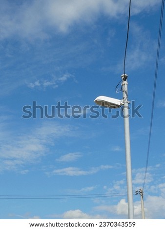 This picture shows a streetlight and a basic utility pole to manage power lines.
These are standing in an open area within the fishing port.
This was taken for use as a background.