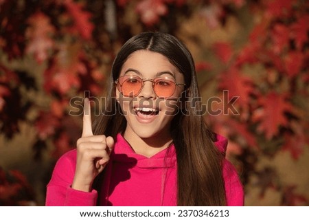 Girl portrait inspired with idea. Autumn teen girl wearing in sunglasses and looks stylish. Fall season. Girl dreams in autumn fall. Autumn mood of adolescent model. Autumn leaves in park outdoor