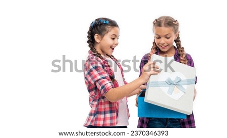 gift to friend. gift box from shopping. children girls with boxes. happy birthday. birthday gift box. children girls sharing gift. Girls exchanging smiles as they uncover the contents of the box