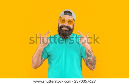 photo of millennial stylish man in sunglasses, point finger. millennial stylish man isolated on yellow. Royalty-Free Stock Photo #2370357629