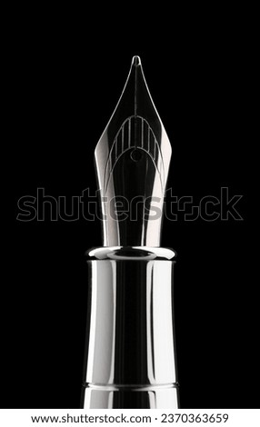 Stylish silver fountain pen on black background, closeup