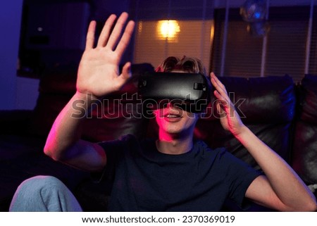 Young caucasian man having fun while using VR glasses