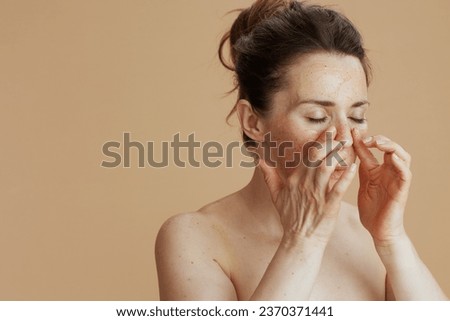 modern female with face scrub isolated on beige. Royalty-Free Stock Photo #2370371441