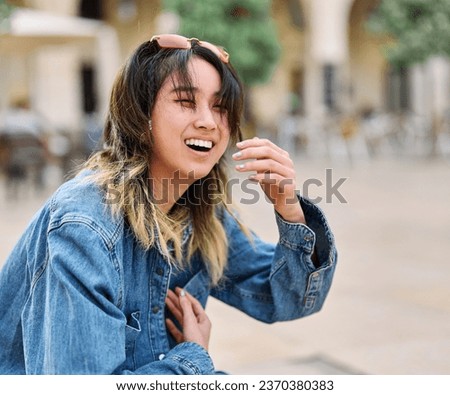 Portrait of a smiling young woman girl happy laughing in the city, tourists visiting destination, summer trip exploring