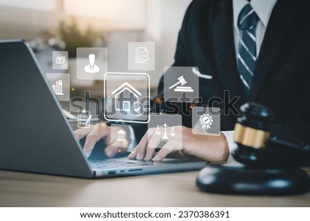 business man uses a computer and house law icons on the dashboard screen to study or search law home, building, or estate and consult a lawyer online tax house Royalty-Free Stock Photo #2370386391