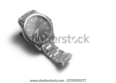 Side tilting shot view, a vintage watch hand used pre owned steel iron metallic men's watch isolated in white table, old iron strap watch
