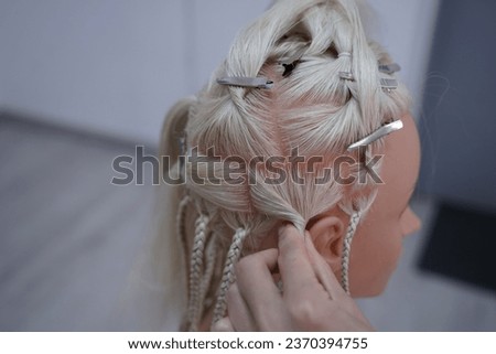 marking a mannequin's head into zones, hairdressing, teaching students, hair cutting, braiding. The master demonstrates to his students the division of the head into zones Royalty-Free Stock Photo #2370394755