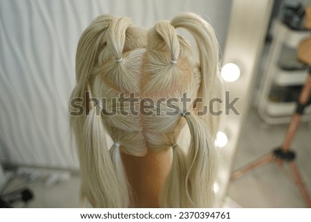 marking a mannequin's head into zones, hairdressing, teaching students, hair cutting, braiding. The master demonstrates to his students the division of the head into zones Royalty-Free Stock Photo #2370394761