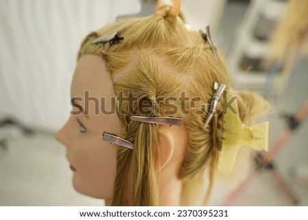 marking a mannequin's head into zones, hairdressing, teaching students, hair cutting, braiding. The master demonstrates to his students the division of the head into zones Royalty-Free Stock Photo #2370395231