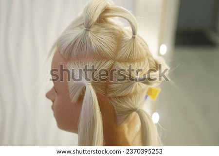 marking a mannequin's head into zones, hairdressing, teaching students, hair cutting, braiding. The master demonstrates to his students the division of the head into zones Royalty-Free Stock Photo #2370395253