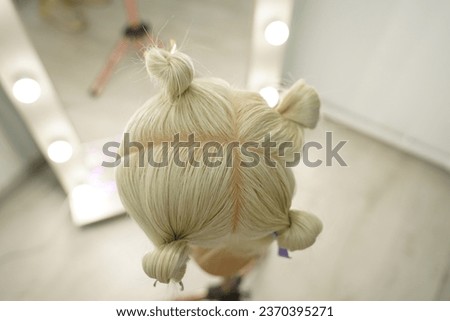 marking a mannequin's head into zones, hairdressing, teaching students, hair cutting, braiding. The master demonstrates to his students the division of the head into zones Royalty-Free Stock Photo #2370395271