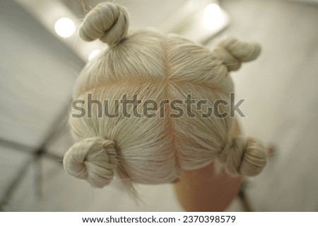 marking a mannequin's head into zones, hairdressing, teaching students, hair cutting, braiding. The master demonstrates to his students the division of the head into zones Royalty-Free Stock Photo #2370398579