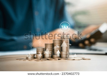 Businessmen use a computer to complete Individual income tax forms online for tax payment. Government state taxes, Data analysis, paperwork, financial research, report and Calculate tax refund. Royalty-Free Stock Photo #2370402773