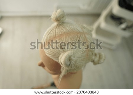 marking a mannequin's head into zones, hairdressing, teaching students, hair cutting, braiding. The master demonstrates to his students the division of the head into zones Royalty-Free Stock Photo #2370403843