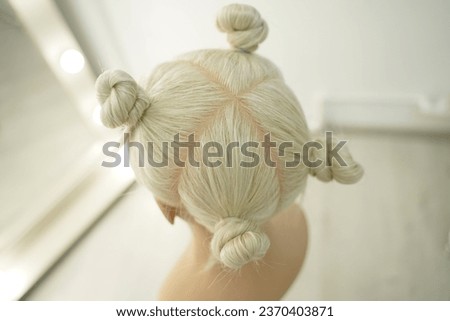 marking a mannequin's head into zones, hairdressing, teaching students, hair cutting, braiding. The master demonstrates to his students the division of the head into zones Royalty-Free Stock Photo #2370403871