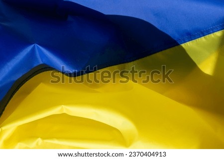 The flag of Ukraine is a banner of two equally sized horizontal bands of blue and yellow.