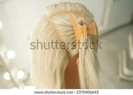 marking a mannequin's head into zones, hairdressing, teaching students, hair cutting, braiding. The master demonstrates to his students the division of the head into zones Royalty-Free Stock Photo #2370406645