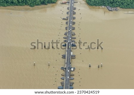 The world's longest movable vehicular pontoon bridge over the Demerara River in Georgetown, Guyana, South America. Aerial view. World tourism, attractions, landscape. Royalty-Free Stock Photo #2370424519