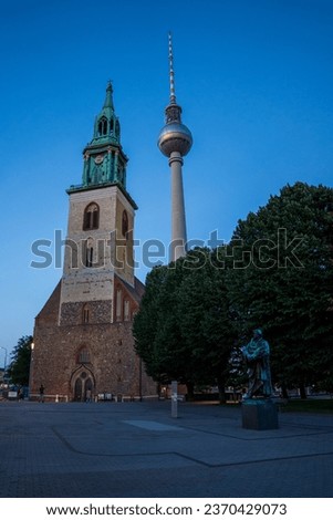 Night picture of the St. Mary's Church with the Berliner Fernsehturm in the background
