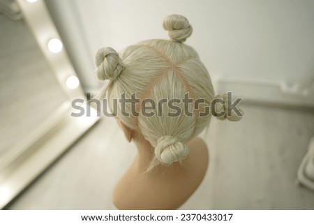 marking a mannequin's head into zones, hairdressing, teaching students, hair cutting, braiding. The master demonstrates to his students the division of the head into zones Royalty-Free Stock Photo #2370433017