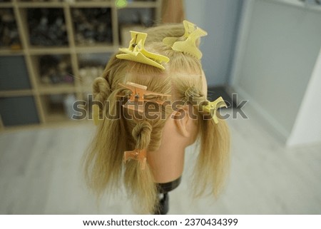 marking a mannequin's head into zones, hairdressing, teaching students, hair cutting, braiding. The master demonstrates to his students the division of the head into zones Royalty-Free Stock Photo #2370434399