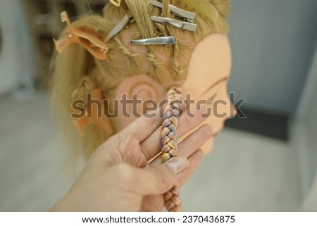 marking a mannequin's head into zones, hairdressing, teaching students, hair cutting, braiding. The master demonstrates to his students the division of the head into zones Royalty-Free Stock Photo #2370436875