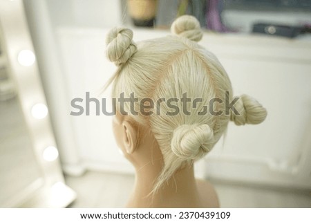 marking a mannequin's head into zones, hairdressing, teaching students, hair cutting, braiding. The master demonstrates to his students the division of the head into zones Royalty-Free Stock Photo #2370439109