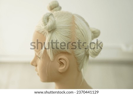 marking a mannequin's head into zones, hairdressing, teaching students, hair cutting, braiding. The master demonstrates to his students the division of the head into zones Royalty-Free Stock Photo #2370441129
