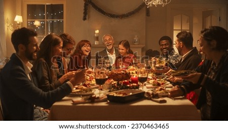 Multi-Generational Family Members Share Funny Stories and Joy During a Christmas Turkey Dinner. Happy Parents and Kids Singing Christmas Carols Together, Dancing Behind a Table and Lighting Sparkles Royalty-Free Stock Photo #2370463465