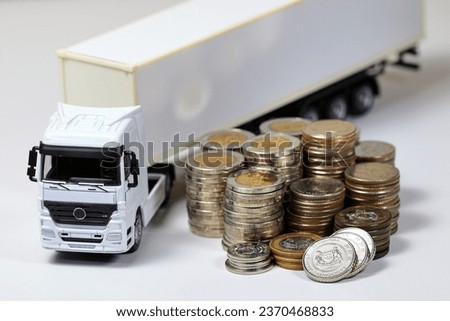 White Container Truck with pile of coins, business and financial concept.