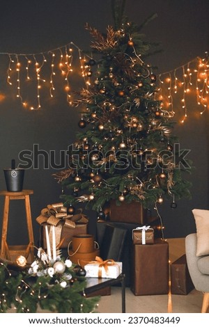 Vertical picture of Christmas tree with beautiful gold and brown Christmas balls and garlands. New year cozy home interior with christmas tree. Christmas card concept. New Year decoration