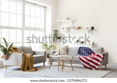 Interior of living room with sofas and USA flag