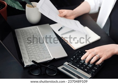Successful Financial Planning: Businesswoman in Accounting. Close-Up of Accountant at Work. Document and Calculator in Hand. Efficient Budget Assessment. Businesswoman in Finance Role.