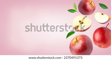 Red apple with leaf and half sliced falling isolated on pink color background. Copy space for text.