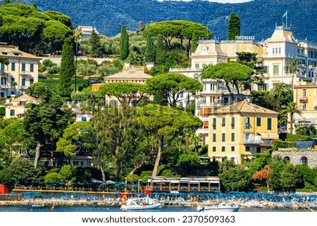 Beautiful Santa Margherita Ligure as taken from the sea with historic buildings, lush foliage and blue water.