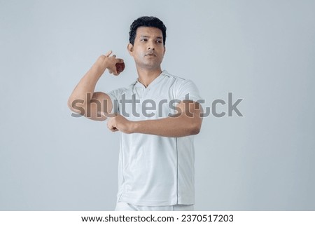 Portrait of cricket man in bowling action indoor studio shoot, cricket concept shoot