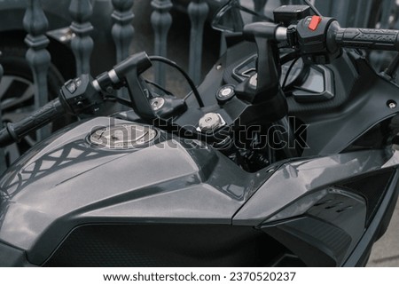 Close up of black gas tank and handlebar of race motorcycle. shiny body of motorbike . selective Focus Handlebar