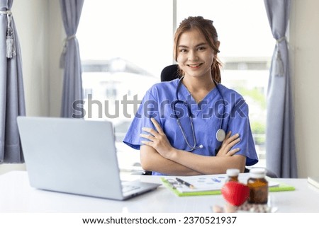 Asian female doctor portrait in hospital office.