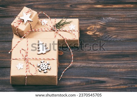Christmas gift box with copy space. Xmas present boxwith decoration on wooden background. Toned.