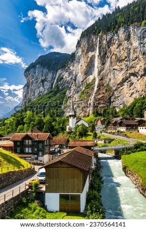 Lauterbrunnen valley with famous church and Staubbach waterfall. Lauterbrunnen village, Berner Oberland, Switzerland, Europe. Spectacular view of Lauterbrunnen valley in a sunny day, Switzerland. Royalty-Free Stock Photo #2370564141