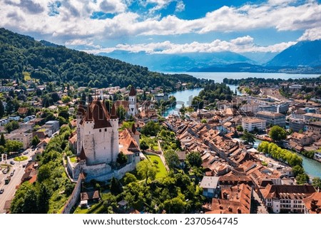 Panorama of Thun city with Alps and Thunersee lake, Switzerland. Historical Thun city and lake Thun with Bernese Highlands swiss Alps mountains in background, Canton Bern, Switzerland. Royalty-Free Stock Photo #2370564745